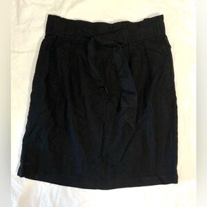 Black A-line cotton skirt with bow. Size small.